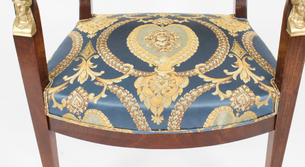 A pair of 19th-century French Empire Revival mahogany armchairs upholstered in blue and gold patterned silk damask featuring gilt ormolu mounts. View XXII