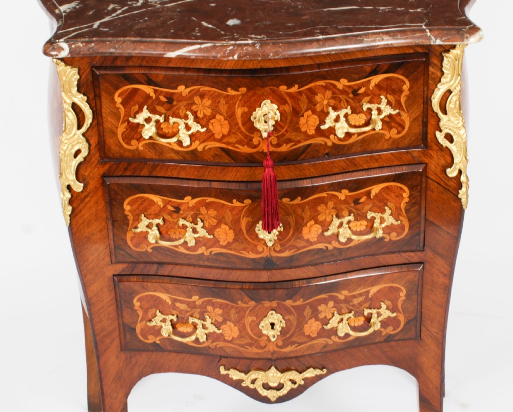 A French Louis XV Revival style marquetry commode featuring floral timber inlays, gilt-bronze mounts, three drawers, and a contoured marble top. View II
