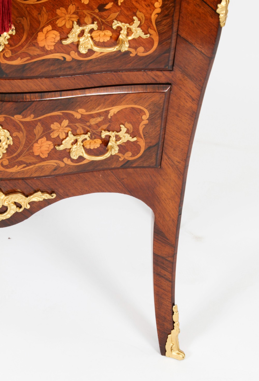 A French Louis XV Revival style marquetry commode featuring floral timber inlays, gilt-bronze mounts, three drawers, and a contoured marble top. View XI