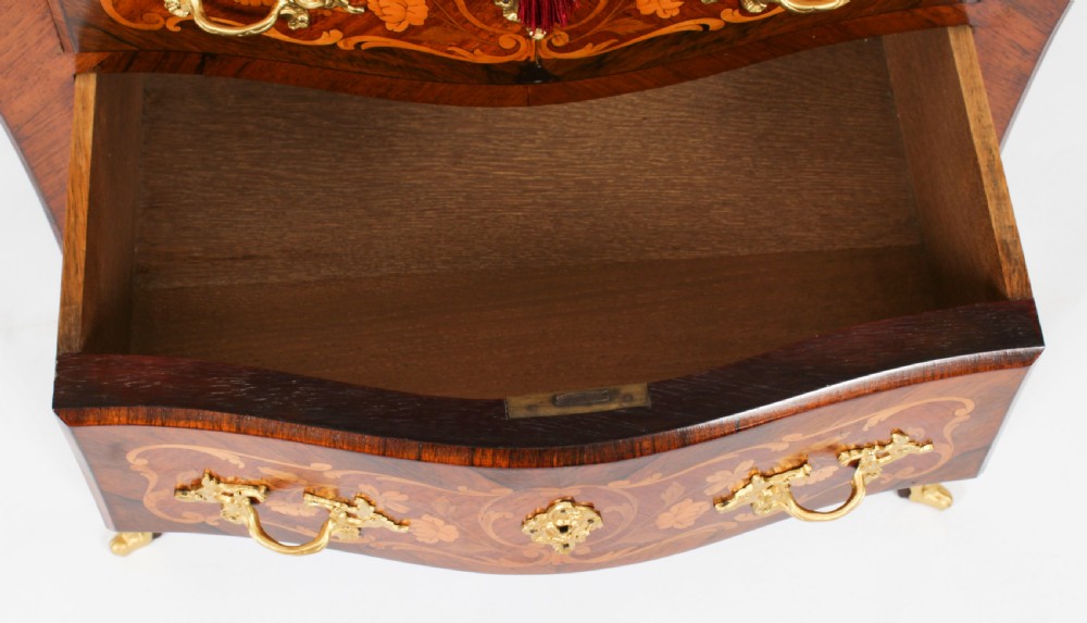 A French Louis XV Revival style marquetry commode featuring floral timber inlays, gilt-bronze mounts, three drawers, and a contoured marble top. View XIII