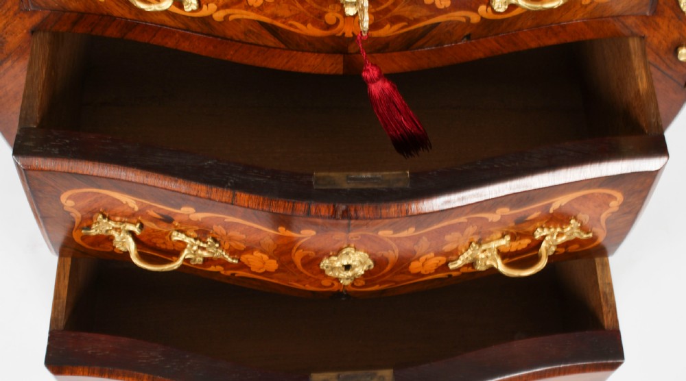 A French Louis XV Revival style marquetry commode featuring floral timber inlays, gilt-bronze mounts, three drawers, and a contoured marble top. View XIV