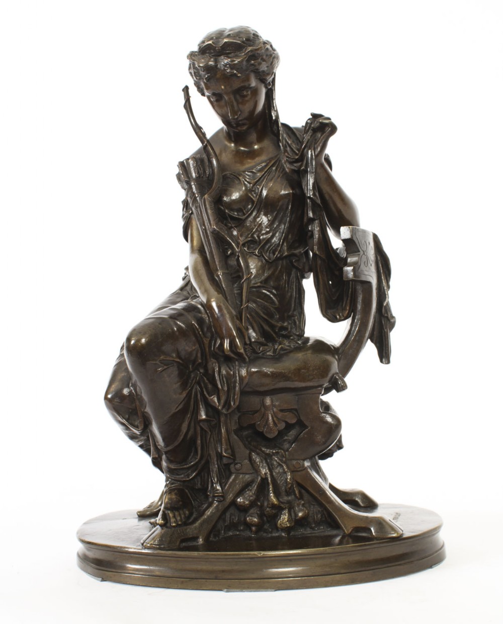 A 19th-century dark patinated bronze sculpture depicting the classical goddess Diana seated on a chair with a bow and quiver, set upon an oval base.