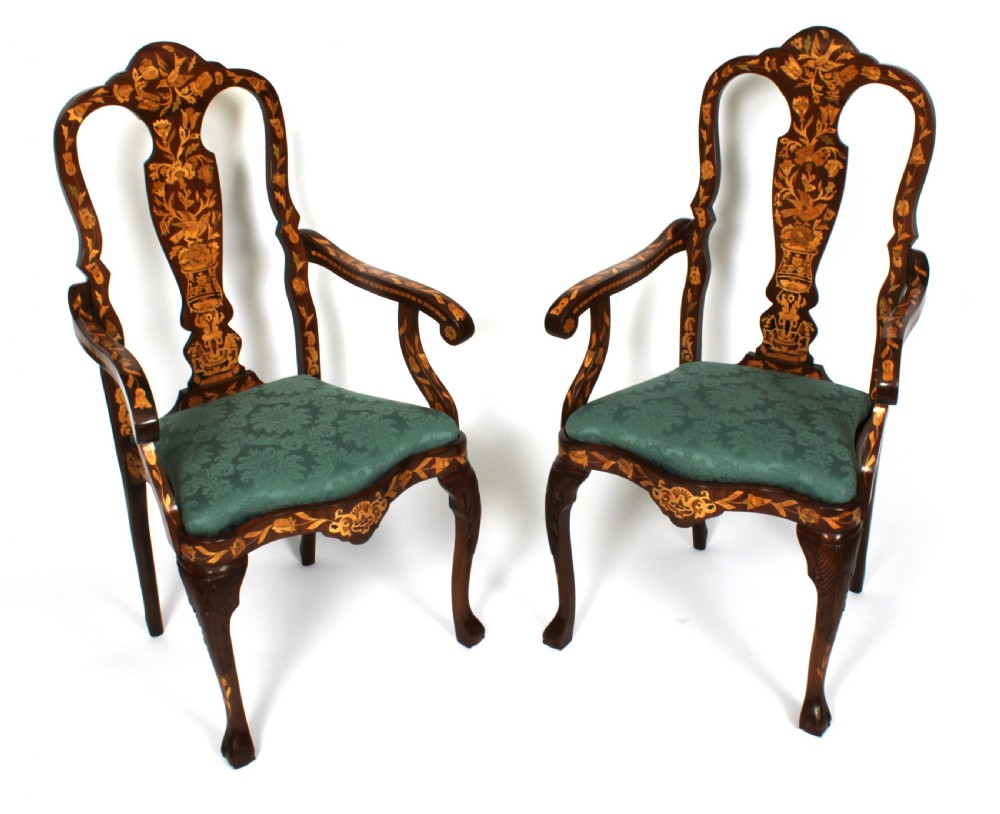 A pair of late eighteenth-century Dutch walnut high back armchairs featuring detailed floral marquetry inlay throughout and green damask drop-in seats. View II