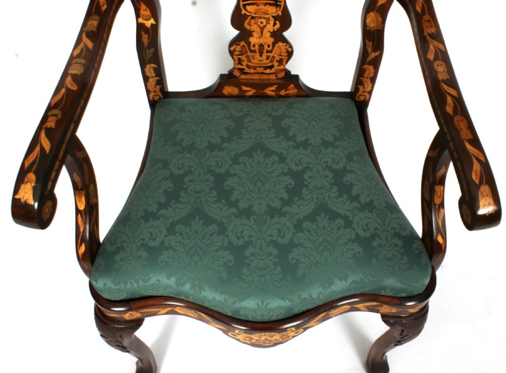 A pair of late eighteenth-century Dutch walnut high back armchairs featuring detailed floral marquetry inlay throughout and green damask drop-in seats. View VI