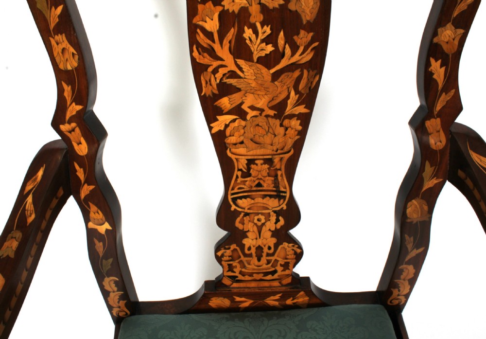 A pair of late eighteenth-century Dutch walnut high back armchairs featuring detailed floral marquetry inlay throughout and green damask drop-in seats. View X