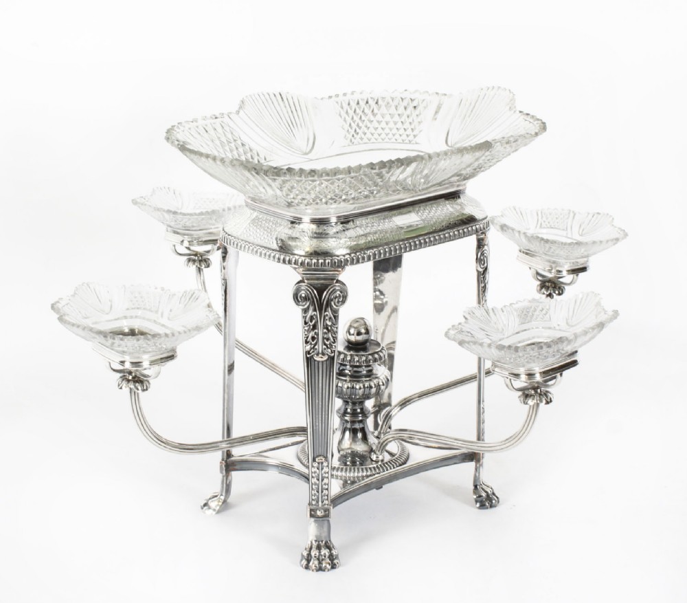 An early nineteenth-century Old Sheffield plate and cut glass epergne centrepiece featuring four branching arms holding smaller crystal dishes beneath a large central glass bowl.