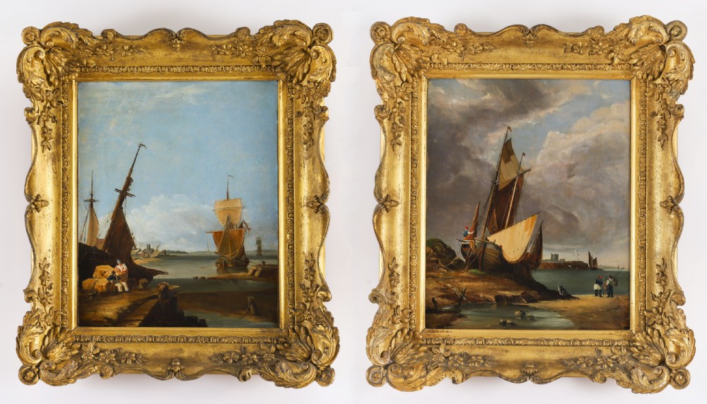 A pair of 19th-century maritime oil paintings depicting sailing vessels on coastal shores, framed in heavy ornate gilded frames.