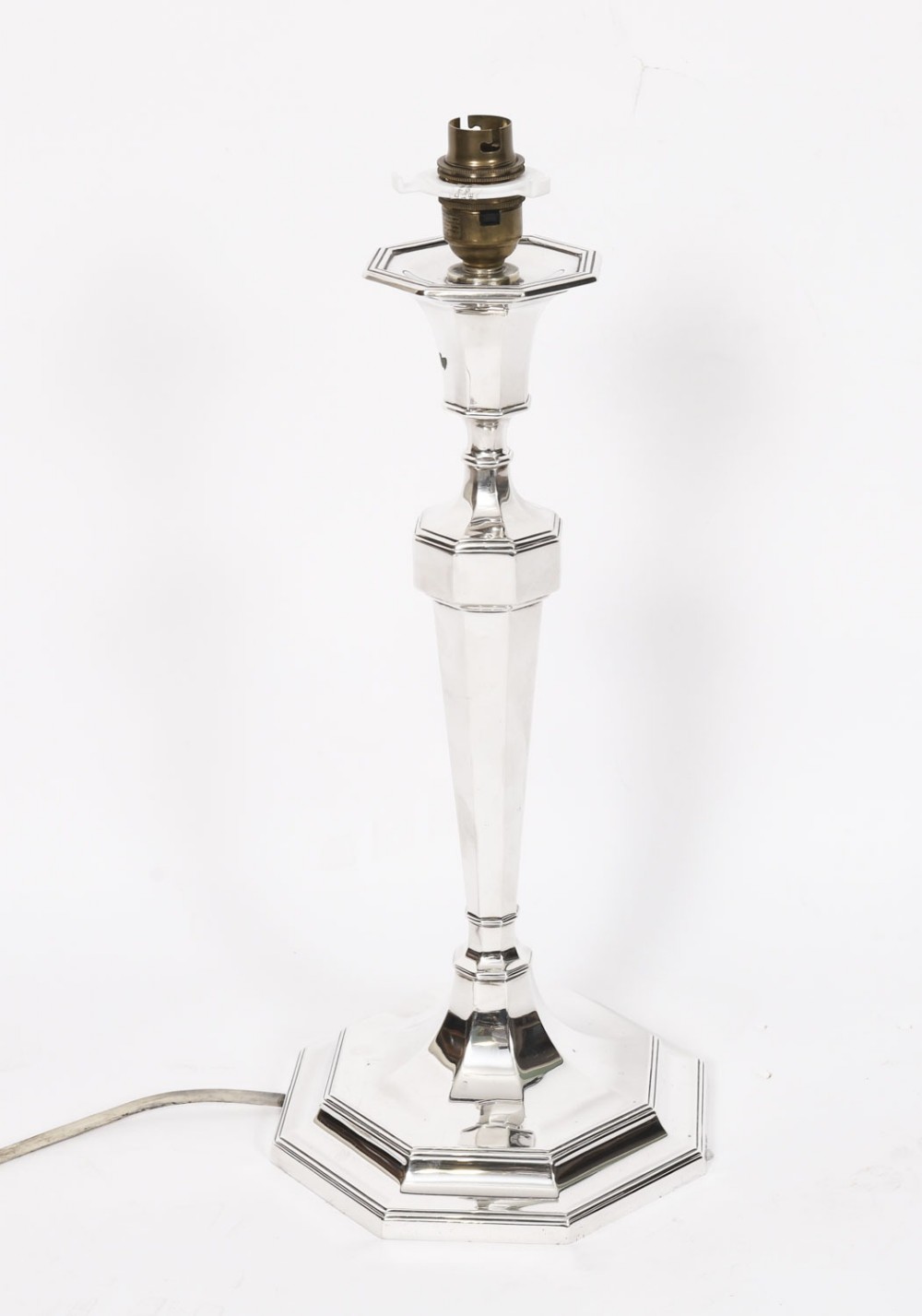 An antique George V Art Deco sterling silver table lamp featuring a faceted octagonal column and stepped base.
