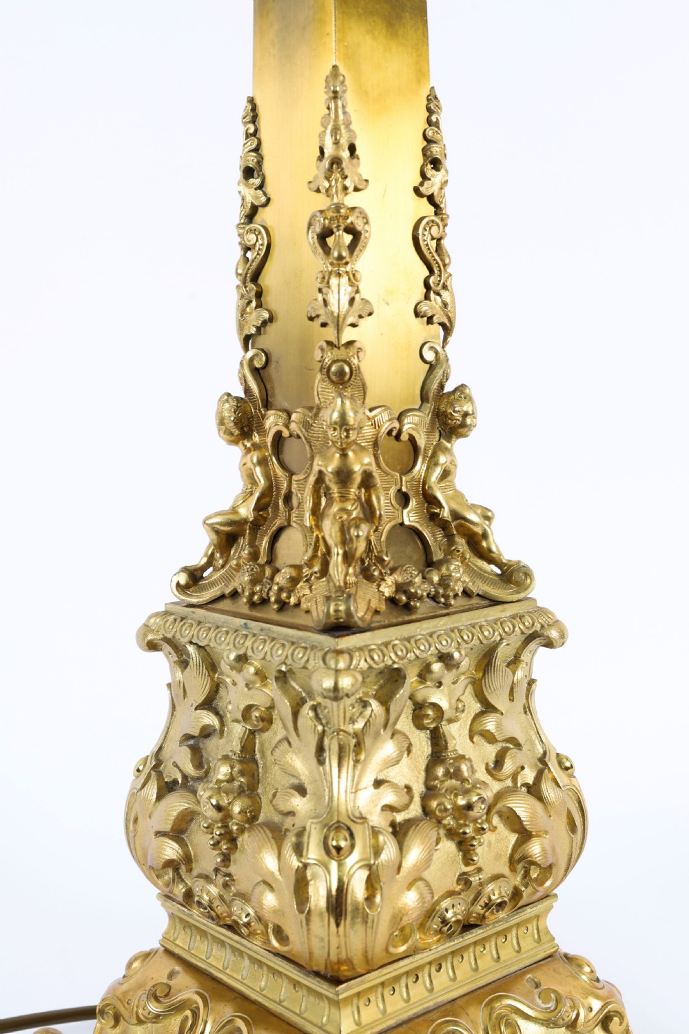 A pair of 19th-century French ormolu table lamps featuring cast gilt bronze bases and cream flared fabric shades with tassel fringe trim. View XIII