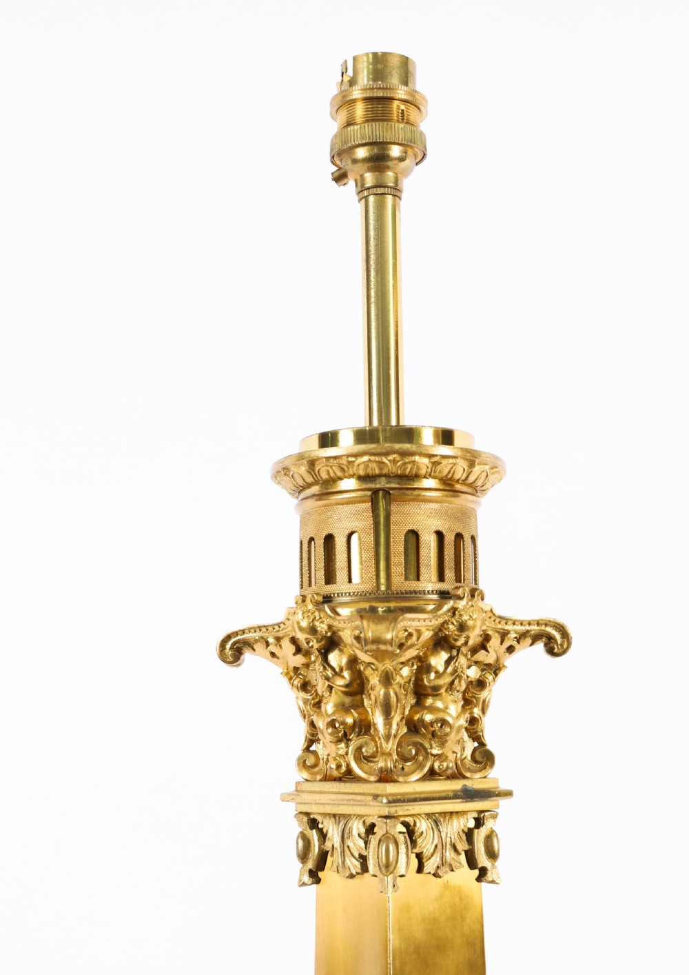 A pair of 19th-century French ormolu table lamps featuring cast gilt bronze bases and cream flared fabric shades with tassel fringe trim. View XIV