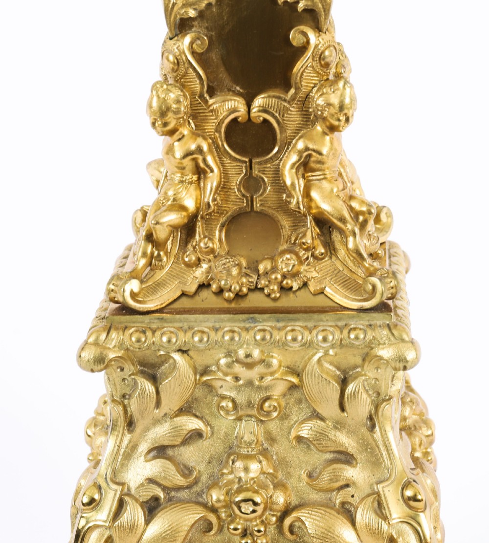 A pair of 19th-century French ormolu table lamps featuring cast gilt bronze bases and cream flared fabric shades with tassel fringe trim. View XVIII