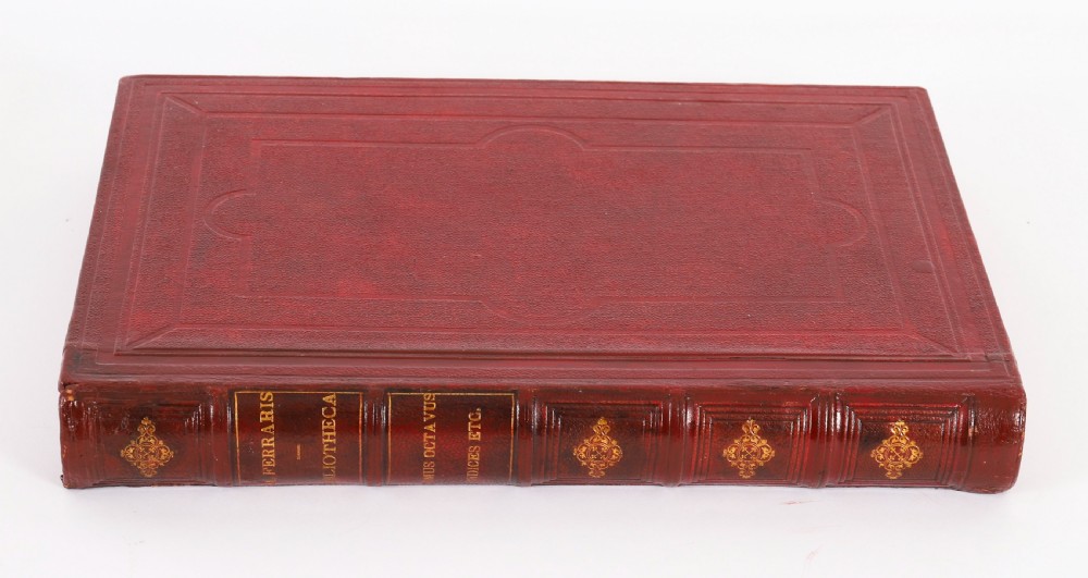 An open red marbled book-form box displaying seven oval cream plaster intaglios behind glass alongside an engraved frontispiece. View IV