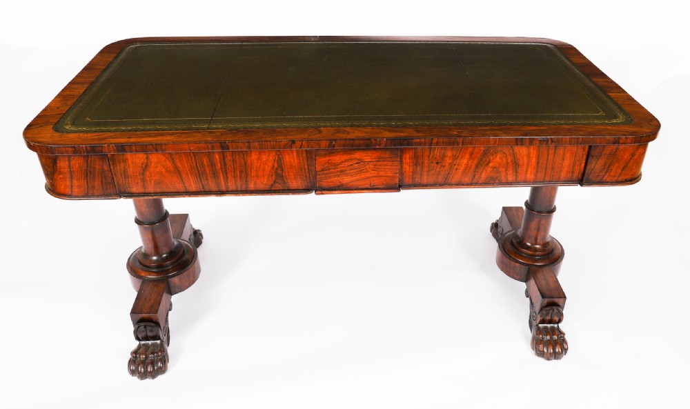 A nineteenth-century William IV writing table crafted from Goncalo Alves wood featuring a green leather top and carved paw feet. View II
