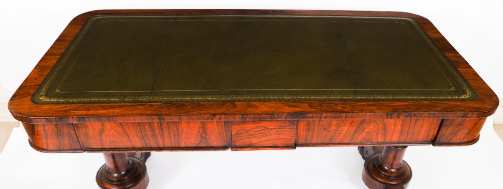 A nineteenth-century William IV writing table crafted from Goncalo Alves wood featuring a green leather top and carved paw feet. View III