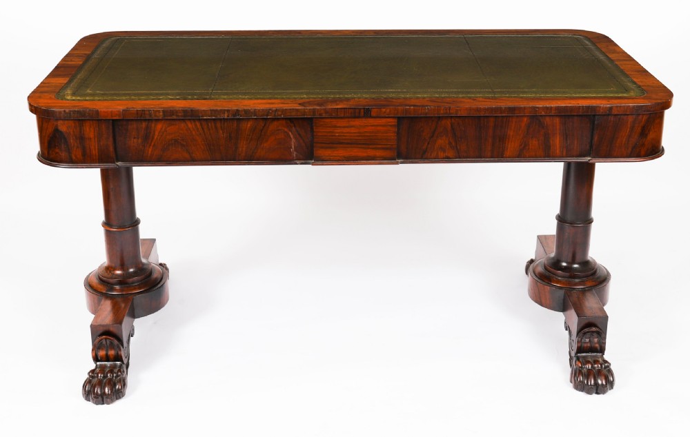 A nineteenth-century William IV writing table crafted from Goncalo Alves wood featuring a green leather top and carved paw feet. View IV