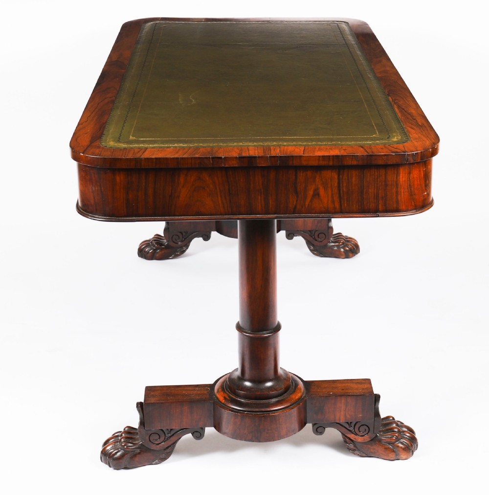 A nineteenth-century William IV writing table crafted from Goncalo Alves wood featuring a green leather top and carved paw feet. View V