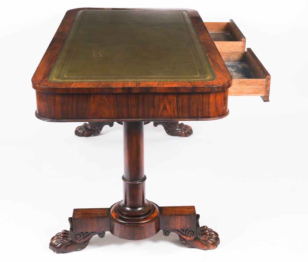 A nineteenth-century William IV writing table crafted from Goncalo Alves wood featuring a green leather top and carved paw feet. View VI