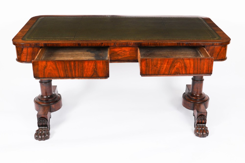 A nineteenth-century William IV writing table crafted from Goncalo Alves wood featuring a green leather top and carved paw feet. View VII