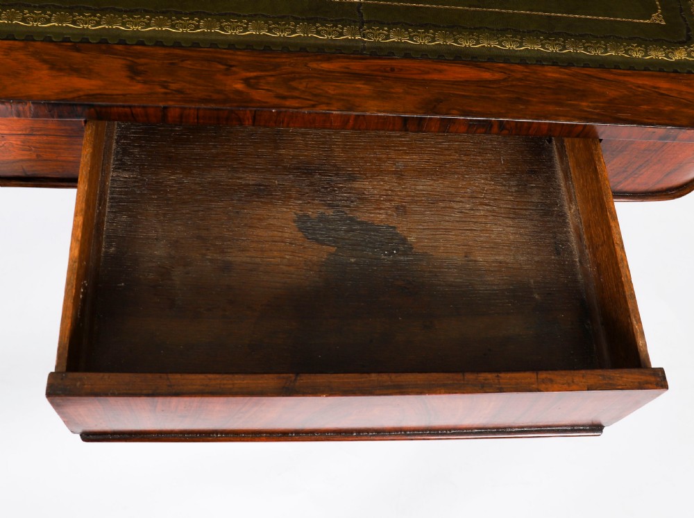 A nineteenth-century William IV writing table crafted from Goncalo Alves wood featuring a green leather top and carved paw feet. View VIII