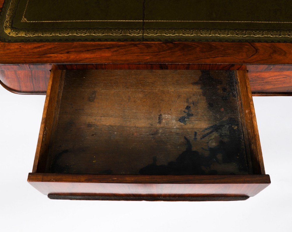 A nineteenth-century William IV writing table crafted from Goncalo Alves wood featuring a green leather top and carved paw feet. View IX