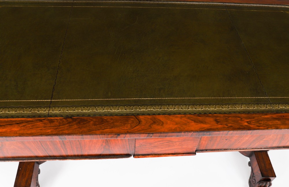 A nineteenth-century William IV writing table crafted from Goncalo Alves wood featuring a green leather top and carved paw feet. View X