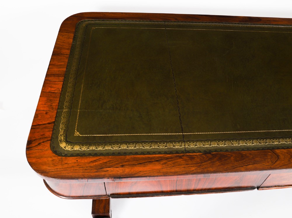 A nineteenth-century William IV writing table crafted from Goncalo Alves wood featuring a green leather top and carved paw feet. View XII