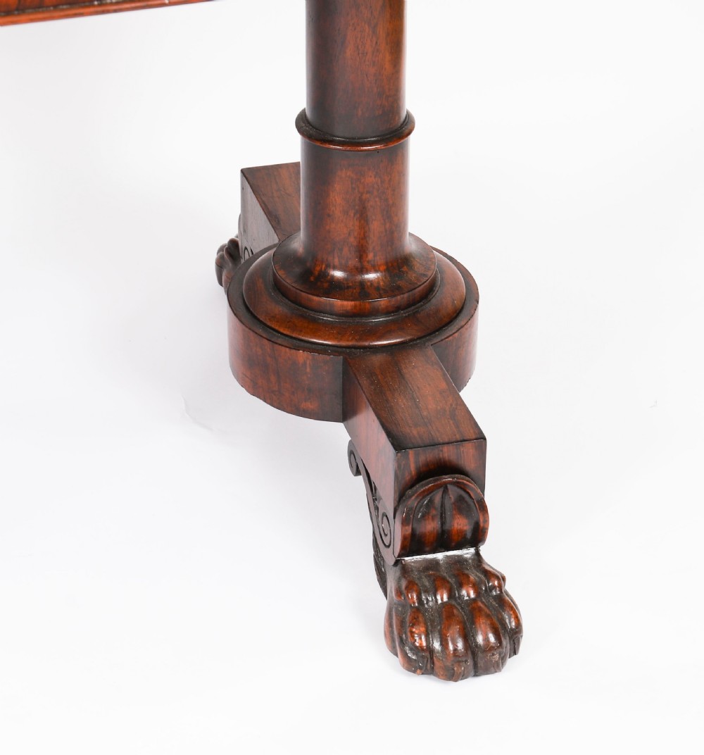 A nineteenth-century William IV writing table crafted from Goncalo Alves wood featuring a green leather top and carved paw feet. View XIV
