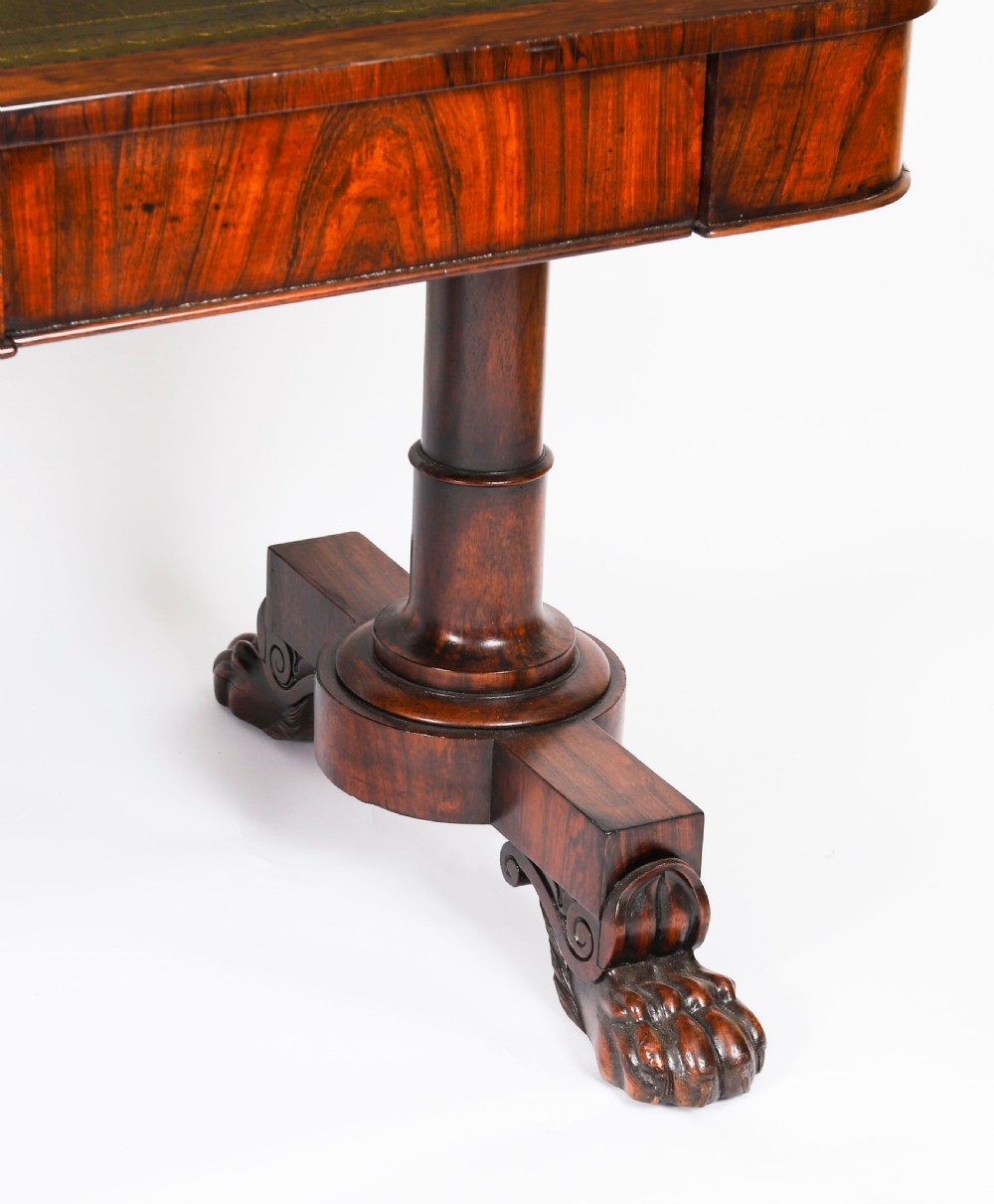 A nineteenth-century William IV writing table crafted from Goncalo Alves wood featuring a green leather top and carved paw feet. View XVI