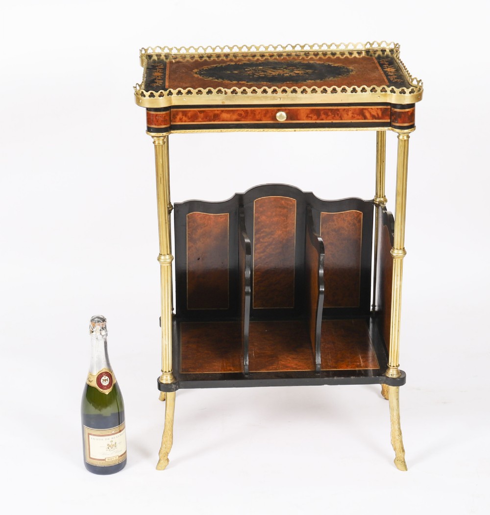 A pair of 19th-century French occasional side tables featuring marquetry tops with brass gallery rails, lower partitioned racks, and gilt metal legs. View VII