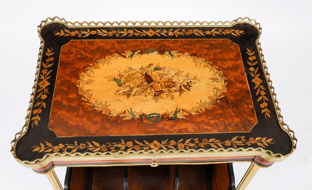 A pair of 19th-century French occasional side tables featuring marquetry tops with brass gallery rails, lower partitioned racks, and gilt metal legs. View IX