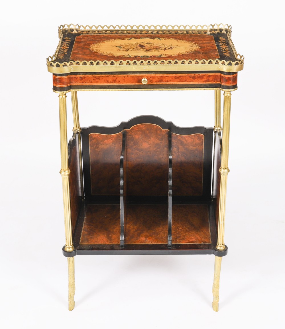 A pair of 19th-century French occasional side tables featuring marquetry tops with brass gallery rails, lower partitioned racks, and gilt metal legs. View X