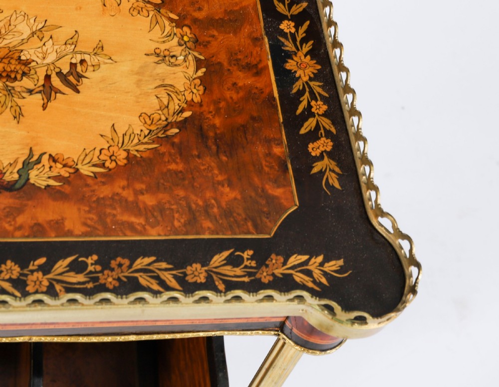 A pair of 19th-century French occasional side tables featuring marquetry tops with brass gallery rails, lower partitioned racks, and gilt metal legs. View XI