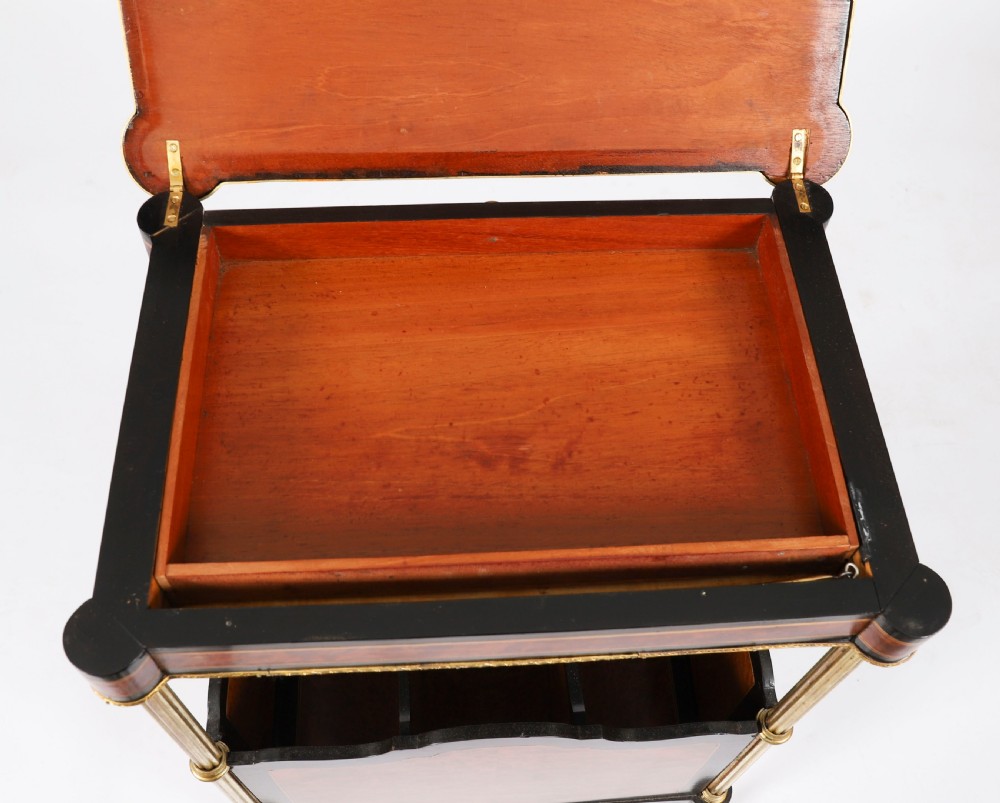 A pair of 19th-century French occasional side tables featuring marquetry tops with brass gallery rails, lower partitioned racks, and gilt metal legs. View XVIII