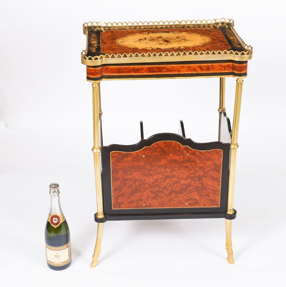 A pair of 19th-century French occasional side tables featuring marquetry tops with brass gallery rails, lower partitioned racks, and gilt metal legs. View XIX