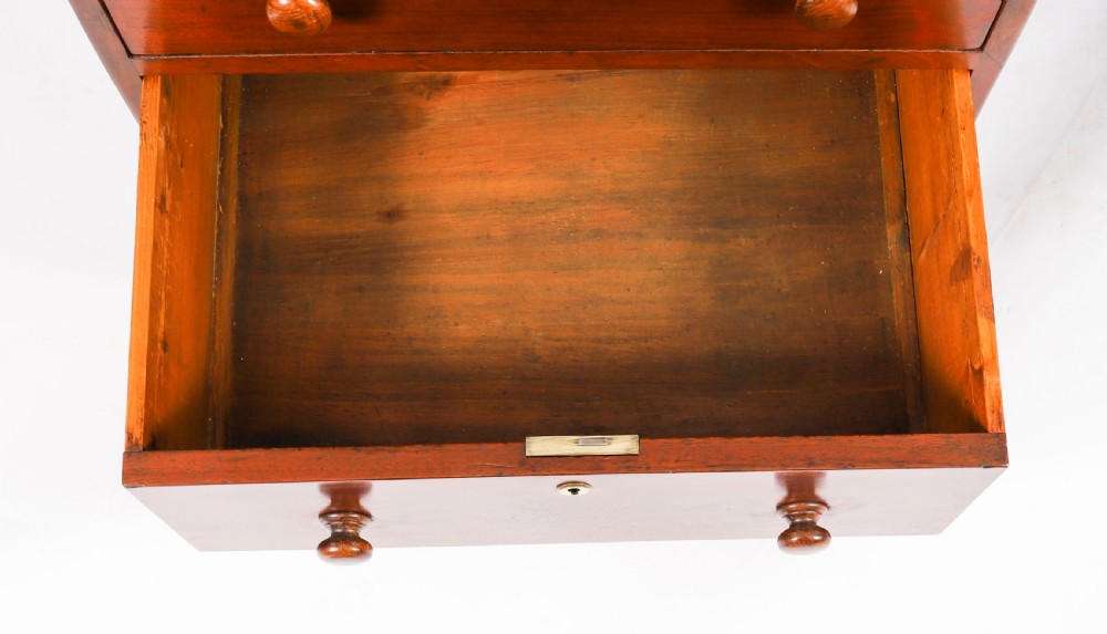 A Victorian flame mahogany partners pedestal desk featuring a green leather inset writing surface and turned wooden knobs. View IX