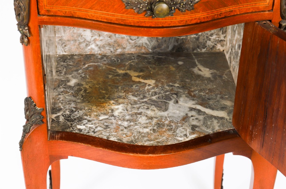 A pair of 19th-century French Louis XV style parquetry bedside cabinets featuring marble tops, three drawers, and cabriole legs with bronze mounts. View X