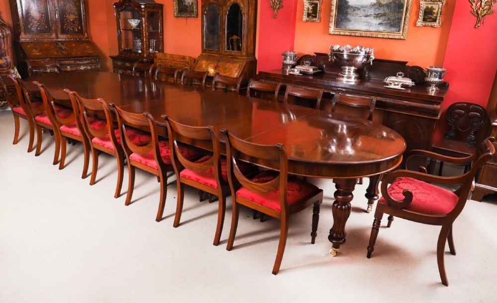 An extended 15ft George III Cuban flame mahogany dining table with turned reeded legs and brass castors. View III