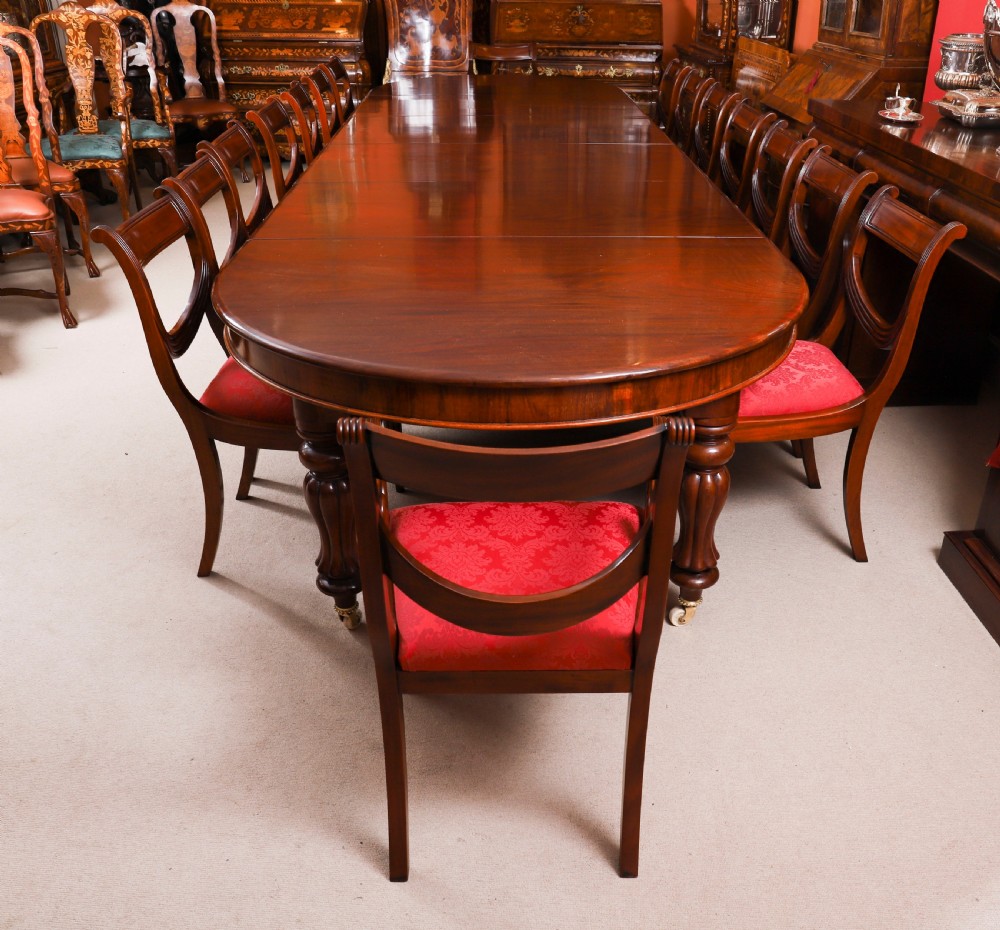 An extended 15ft George III Cuban flame mahogany dining table with turned reeded legs and brass castors. View IV