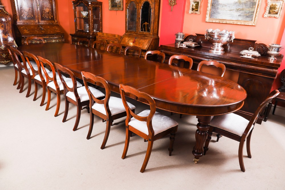 An extended 15ft George III Cuban flame mahogany dining table with turned reeded legs and brass castors. View V