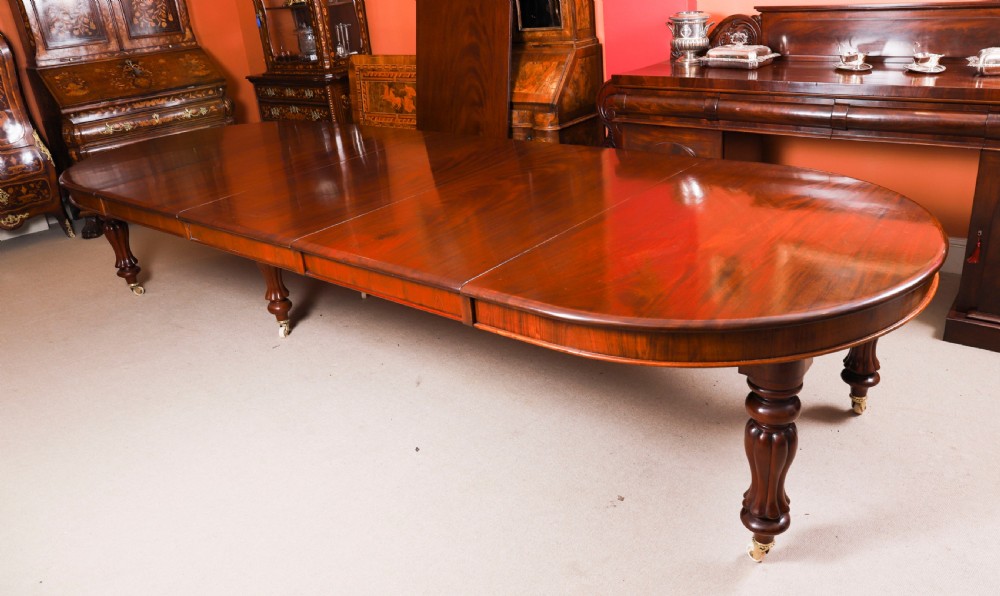 An extended 15ft George III Cuban flame mahogany dining table with turned reeded legs and brass castors. View VI
