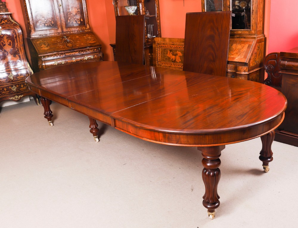 An extended 15ft George III Cuban flame mahogany dining table with turned reeded legs and brass castors. View VII