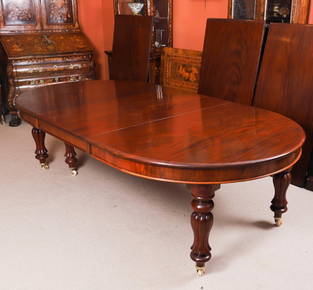 An extended 15ft George III Cuban flame mahogany dining table with turned reeded legs and brass castors. View VIII