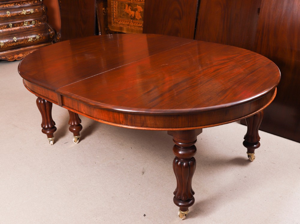 An extended 15ft George III Cuban flame mahogany dining table with turned reeded legs and brass castors. View IX