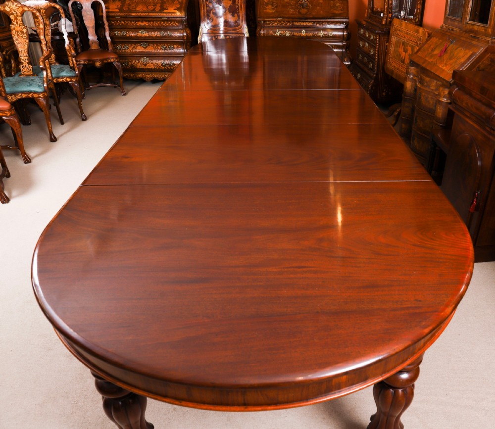 An extended 15ft George III Cuban flame mahogany dining table with turned reeded legs and brass castors. View X