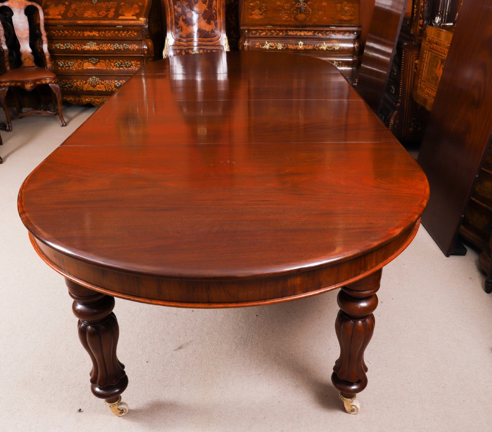 An extended 15ft George III Cuban flame mahogany dining table with turned reeded legs and brass castors. View XII