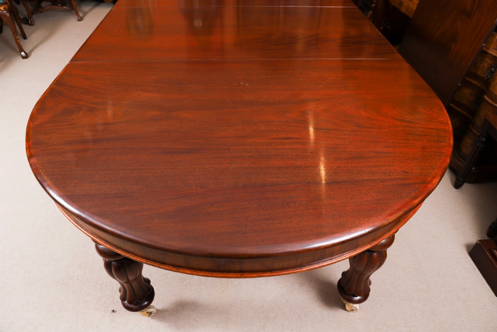 An extended 15ft George III Cuban flame mahogany dining table with turned reeded legs and brass castors. View XIV