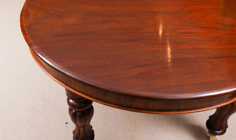 An extended 15ft George III Cuban flame mahogany dining table with turned reeded legs and brass castors. View XVI