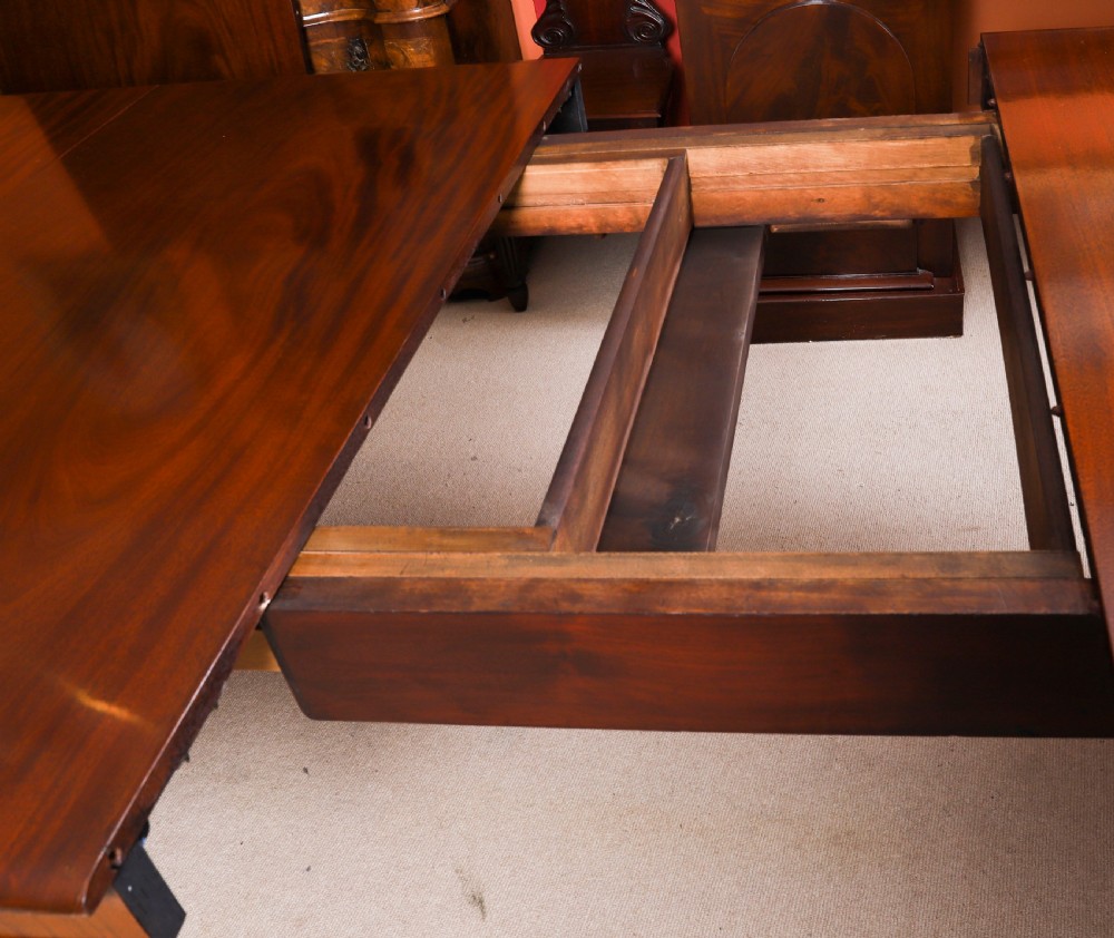 An extended 15ft George III Cuban flame mahogany dining table with turned reeded legs and brass castors. View XVII