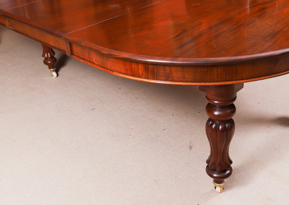 An extended 15ft George III Cuban flame mahogany dining table with turned reeded legs and brass castors. View XVIII