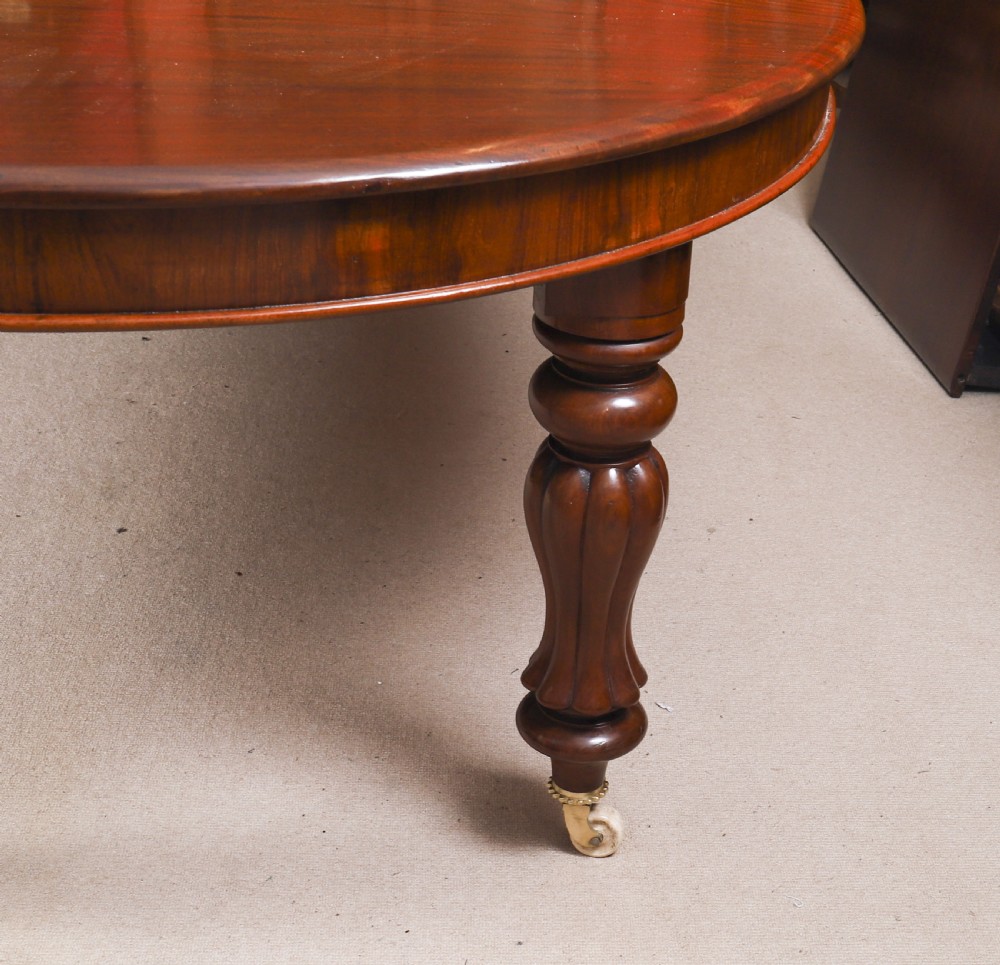 An extended 15ft George III Cuban flame mahogany dining table with turned reeded legs and brass castors. View XIX